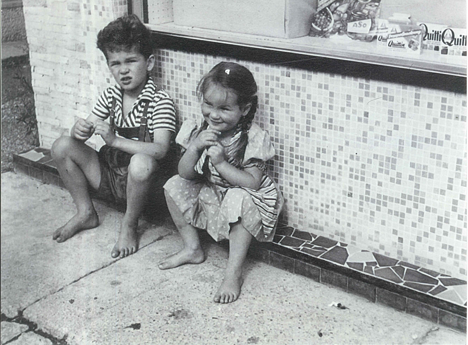 Young Heini Staudinger and his sister in front of their parents grocery